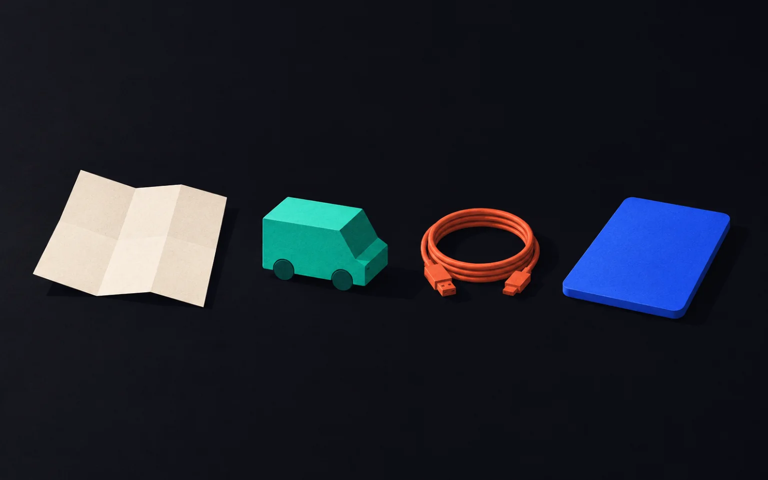 Still life: a folded dispatch sheet, a small turquoise van, a coiled cable and a blue tablet on a dark table